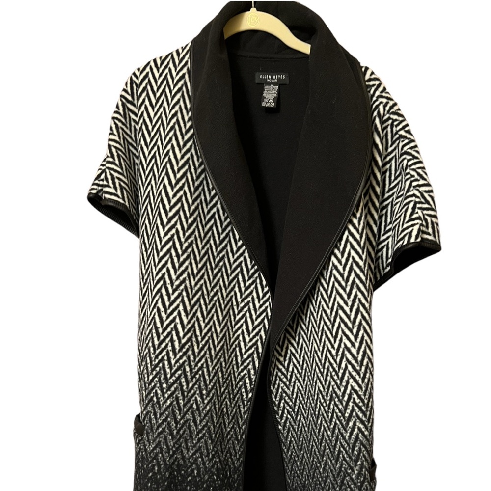 Nice.Vest 100% polyester w/faux letter trim great way to keep warm & look sharp!